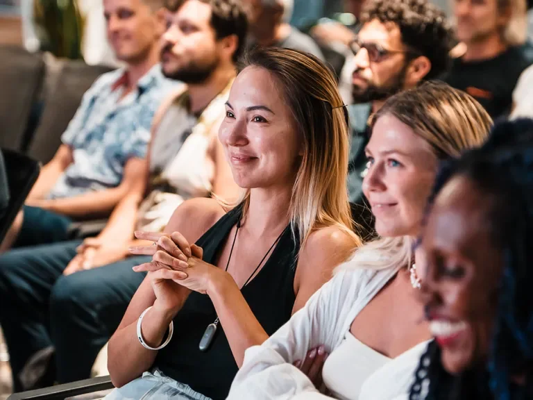 Network School community members listening to a talk